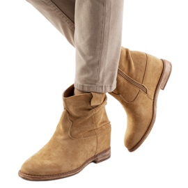 Mörkbeige stövlar på en inomhus Hunjet kilklack