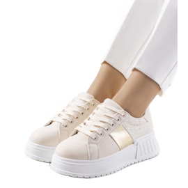 Beige sneakers på Avenid-plattformen gyllene