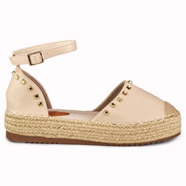 Beige espadrillor med dubbar vid ankeln