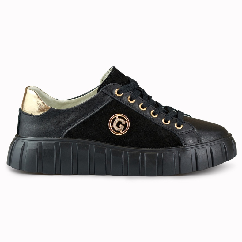 Svarta sportskor i läder med gulddetaljer