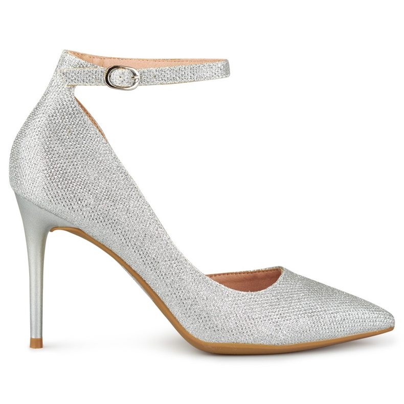 Glänsande silvernålar fästa vid ankeln silver-