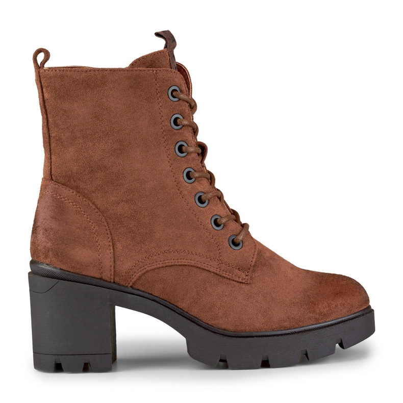 Bruna stövlar i mocka på en bekväm stolpe