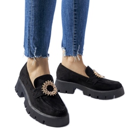 Svarta mockasiner dekorerade med ett Stanislas-spänne