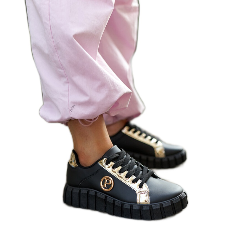 Svarta och guldiga sneakers med massiv Bionda-sula