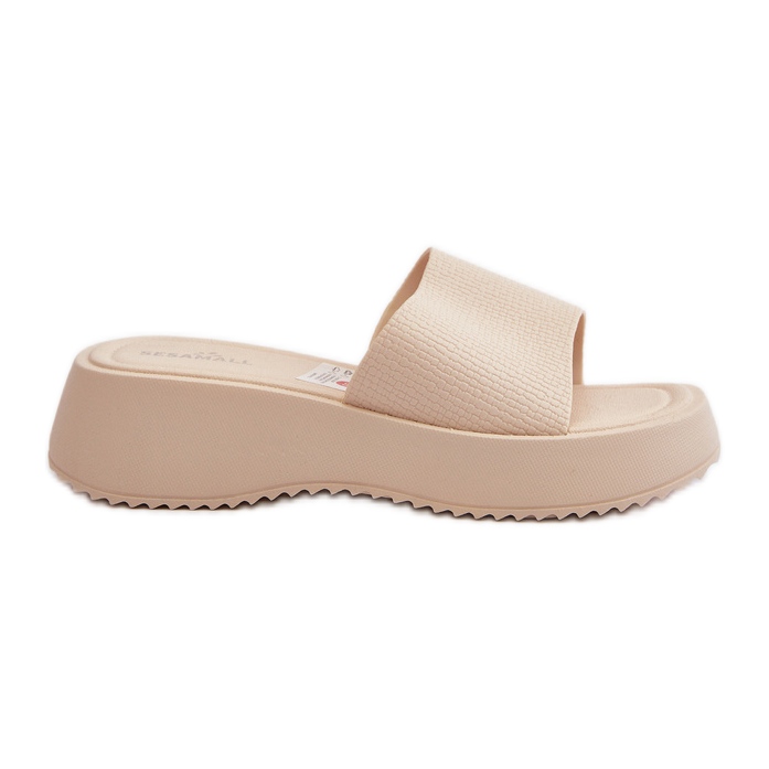 Kvinnors flip-flops på en plattform och kil, ljusbeige vimarils