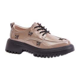 Damskor med mörkbeige dekorationer