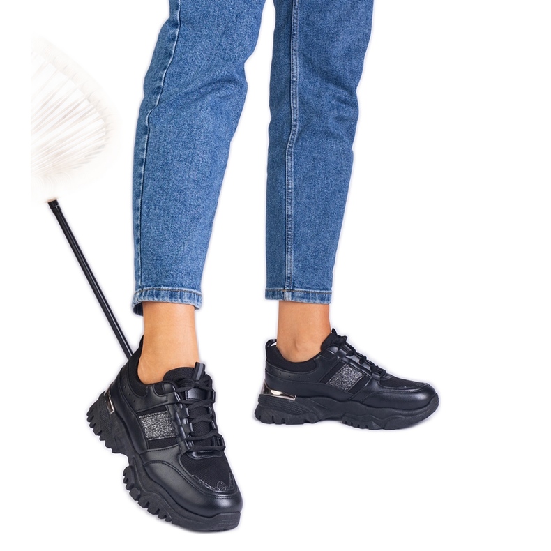 Svarta kvinnors sneakers dekorerade med glitter