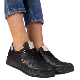 Svarta kvinnors sneakers med gyllene glitter