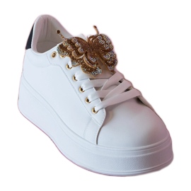 Svartvita sneakers dekorerade med en fjäril med zirkoner