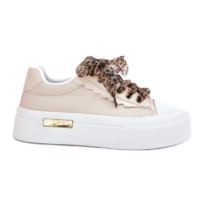 Kvinnors sneakers på en massiv plattform med dekorativ snörning beige