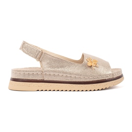 Goodin Guldsandaler på plattformen med en stift gyllene