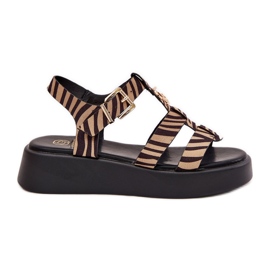 Kvinnors sandaler på plattformen med en gyllene detalj av beige-svart zebra