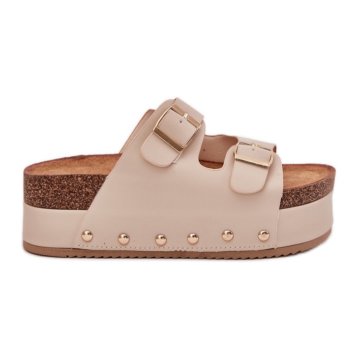 Kvinnors flip flops med spännen på en massiv plattform beige