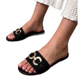 Svarta flip flops med en gyllene dekoration på baren