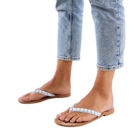 Vita flip -flops dekorerade med stenar
