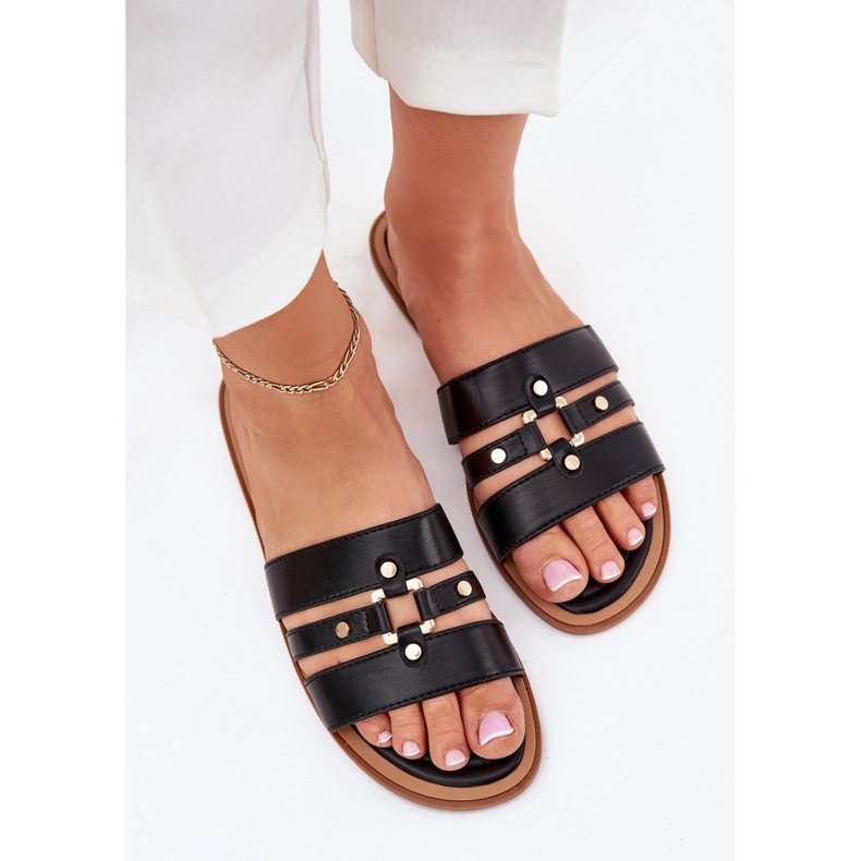 Platta kvinnors flip flops med gyllene detalj svart