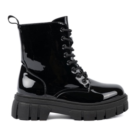 Shelvt Svarta lackerade arbetare på en massiv sula