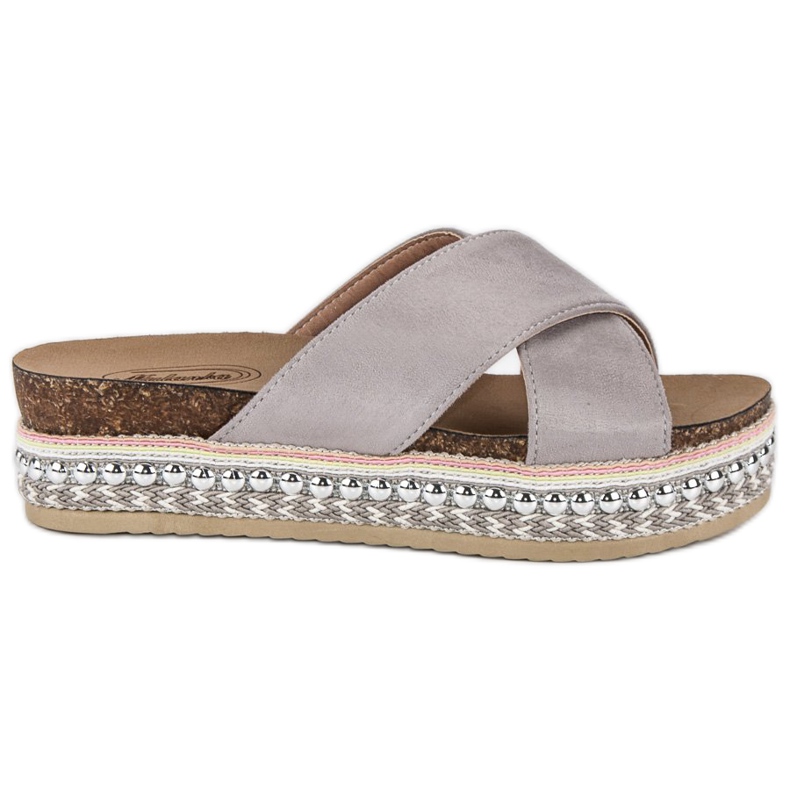 Gråa tofflor på plattformen