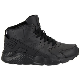 Svarta stövlar ovanför fotleden