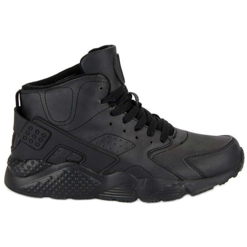 Svarta stövlar ovanför fotleden