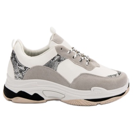 Vita sneakers med ett mönster svart brun