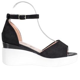 Weide Mockasandaler på en vit kil svart