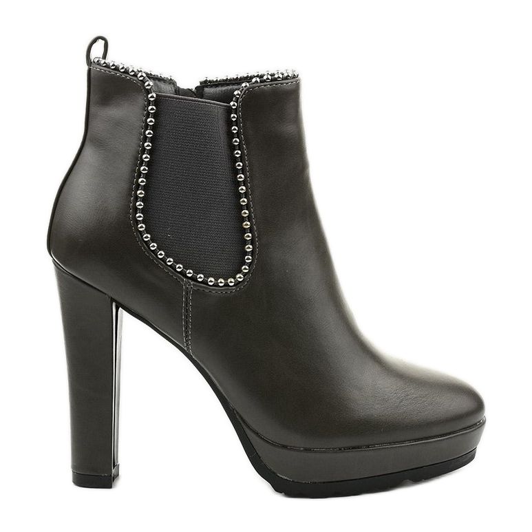 Grå stövlar på stolpen med dragkedja och cirkuselastik