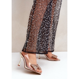 Transparenta högklackade sandaler med en glänsande guldrosett gyllene 2