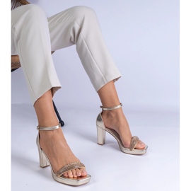 Gyllene eleganta sandaler på pelaren med zirkoner 1