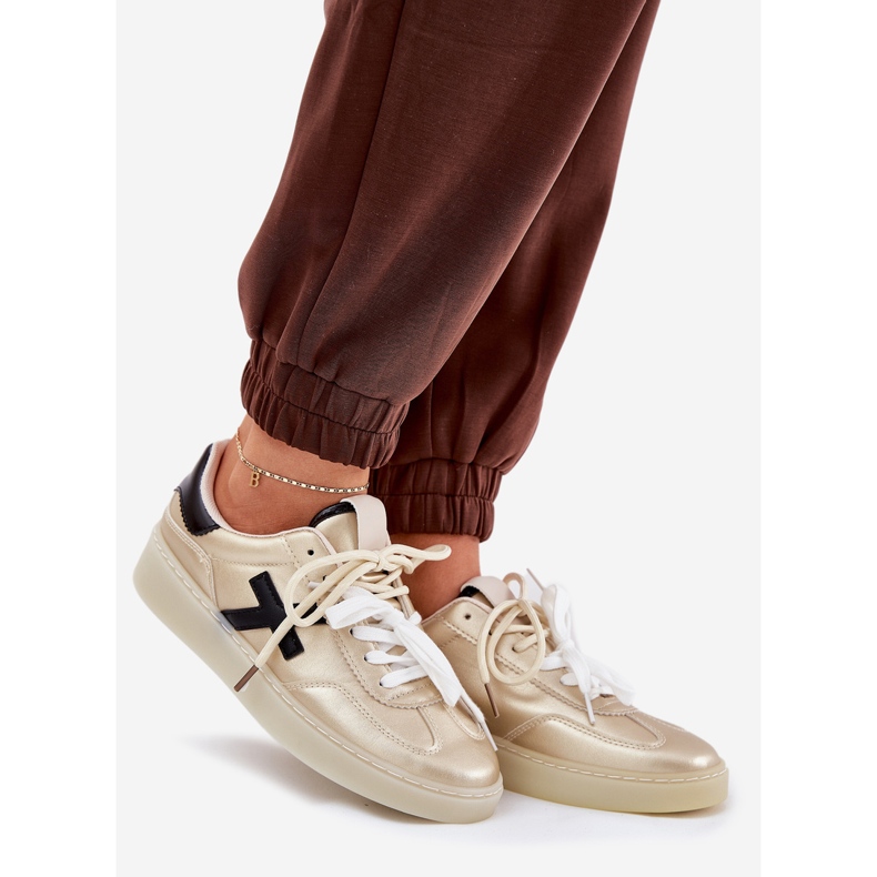 Låga kvinnors sportskor gyllene 1