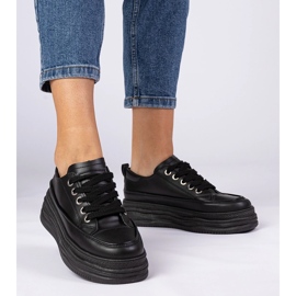 Svarta kvinnors sneakers på en hög sula 3
