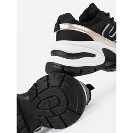 Svarta kvinnors sneakers med gyllene skär 1