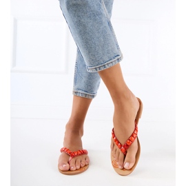 Orange flip -flops flip -flops dekorerade med stenar 1