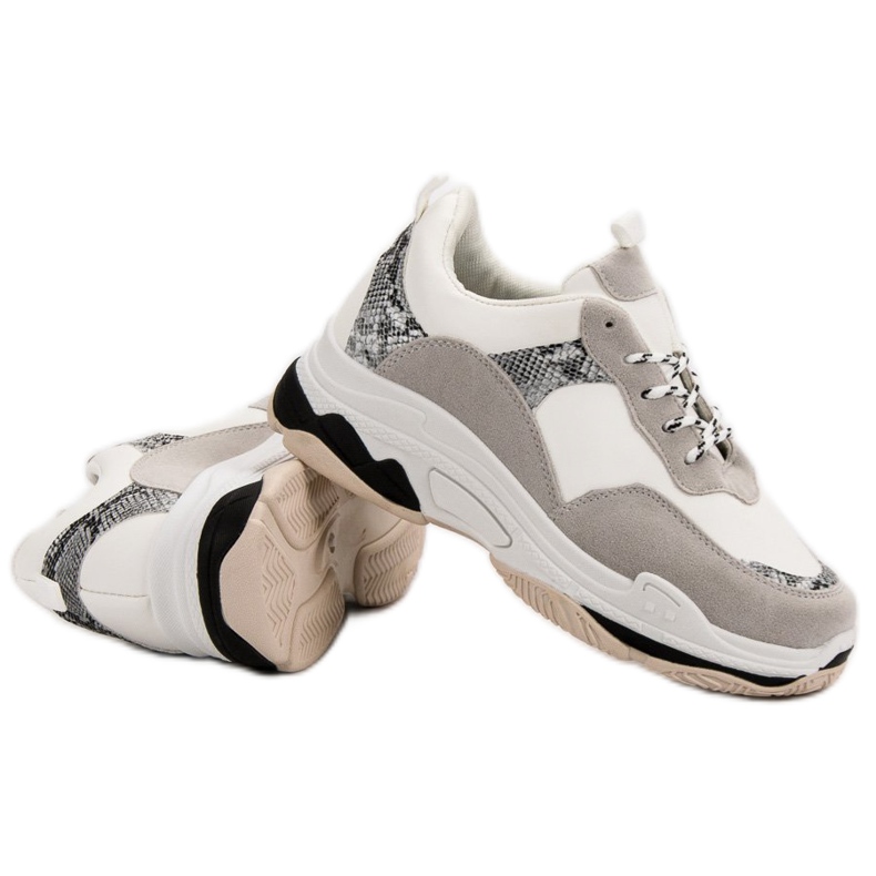 Vita sneakers med ett mönster svart brun 1